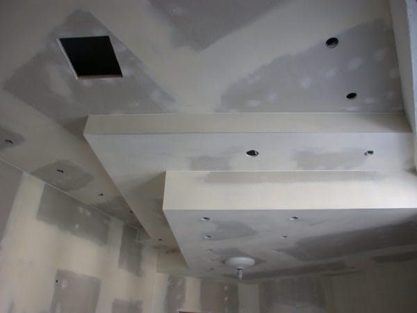 Abgehängte Gipskartondecke mit vorbereiteten Spot-Ausschnitten in Arztpraxis
