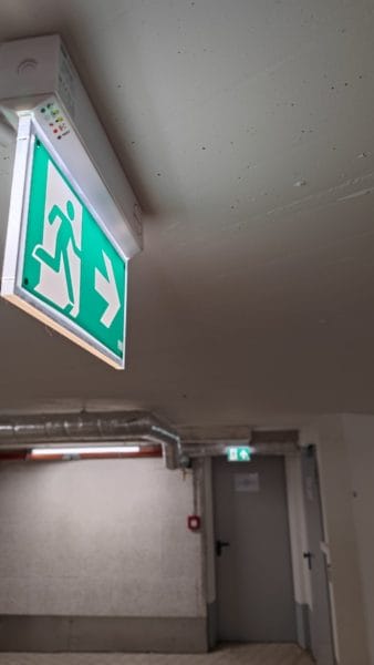 Rettungszeichenleuchte als Teil der Notbeleuchtung in einem Gebäude – installiert von SHI Elektro Augsburg